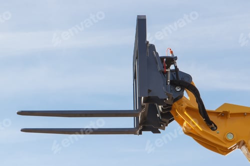 Preview: Part of forklift loader or stacker on blue sky background. Modern technology