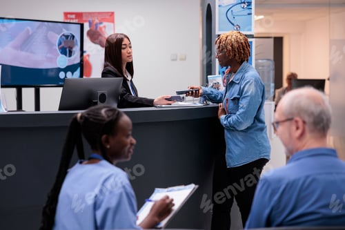 Preview: African american woman paying appointment