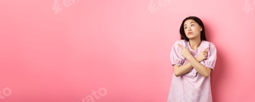 Preview: Indecisive asian woman cant decide, pointing fingers sideways and look pensive aside, making choice