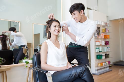 Preview: Hairdresser working on customer