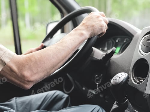 Preview: A man is driving a truck. Close-up. A man's hand switches the gear lever