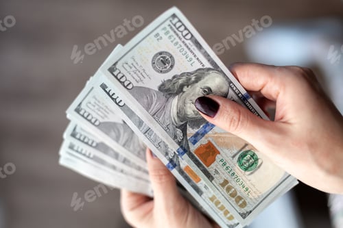 Preview: Close up female hand Counting and holding money us dollar.