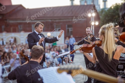Preview: Conductor directing orchestra performance on the street