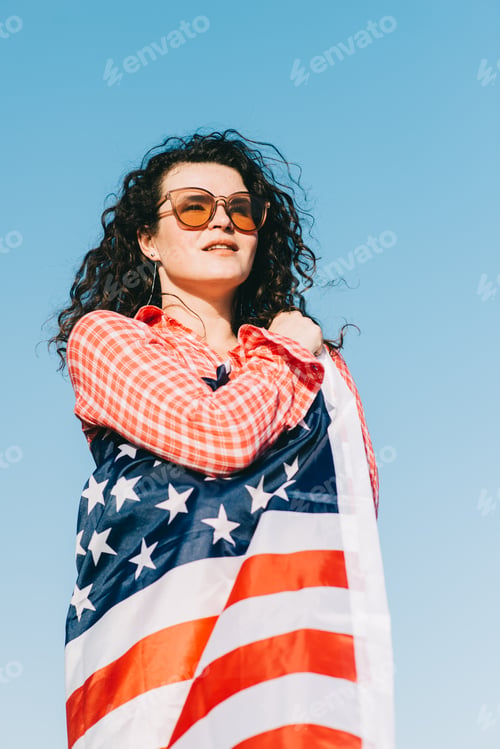 Preview: Girl with an American flag. Independence Day concept