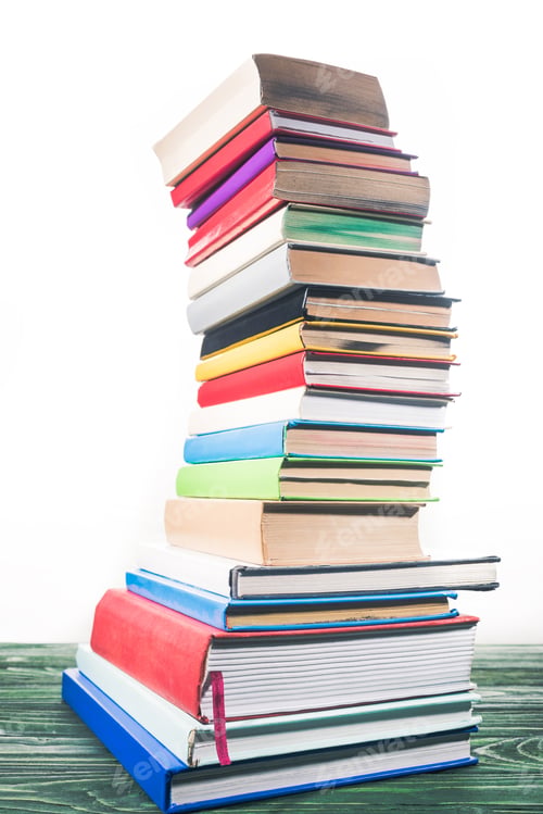 Preview: Bent tower of stacked books on white background