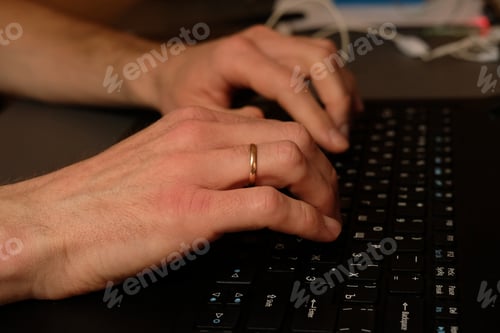 Preview: male hands on a laptop. wedding ring