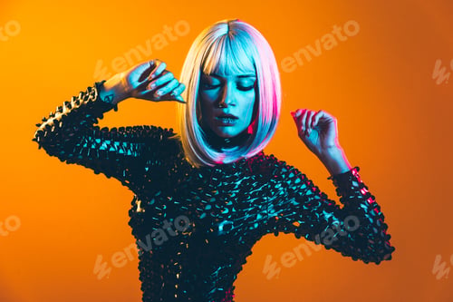 Preview: Young woman with grey hair dancing and celebrate. Colored gel portraits