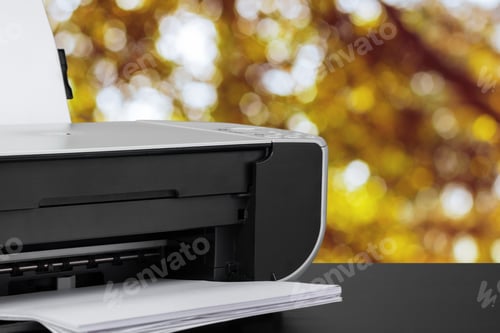 Preview: Compact laser printer on black desk against blurred background