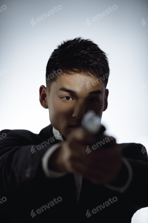 Preview: Portrait of Elegant Spy in Suit With Weapon