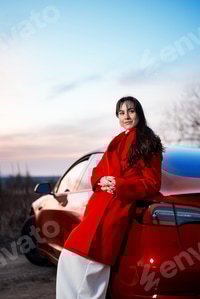 Preview: Woman posing near a red car