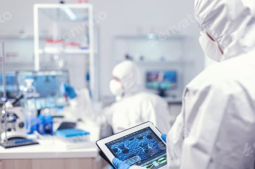 Preview: Doctor in ppe suit during coronavirus outbreak working in laboratory