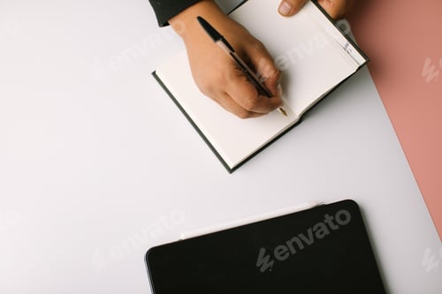 Preview: Hand writing in a blank notebook