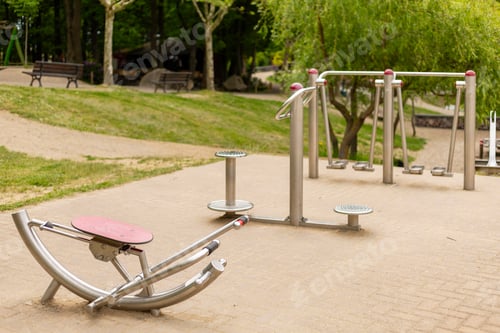 Preview: Various outdoor fitness machines are set up in a serene community park