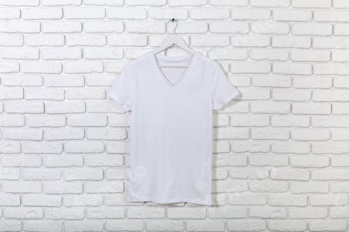 Preview: White T-Shirt on Hanger Against White Brick Wall