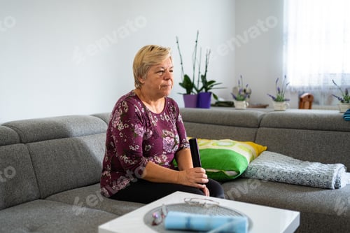 Preview: Retired senior woman at home, doing her daily chores. Old woman living alone in a house. Seniors.