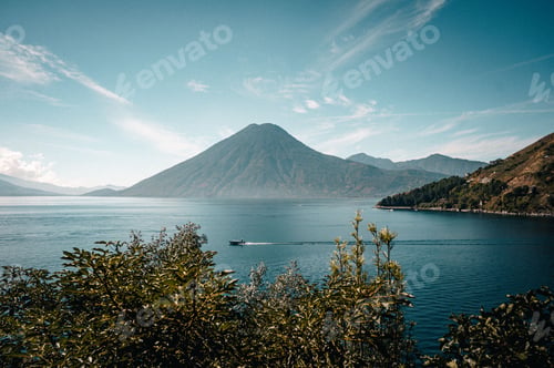 Preview: Aerial shot of the Lake Atitlan in the background of mountains on a cloudy day.