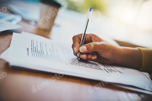 Preview: Cropped shot of a businesswoman completing paperwork at a desk