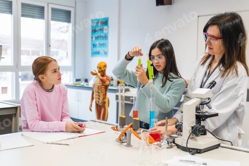 Preview: Students and teacher performing chemistry experiment in laboratory