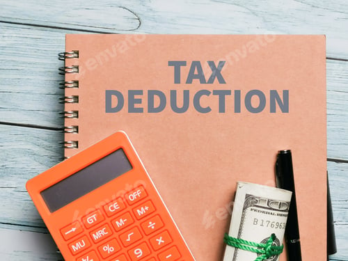 Preview: Top view image phrase tax deduction on the notebook with a pen on the table.