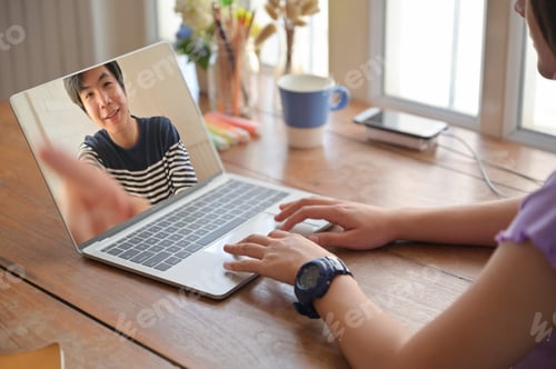 Preview: Young women use laptop for online video chat with male friend.