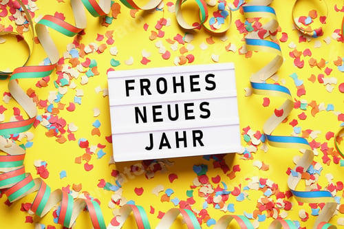 Preview: Frohes neues Jahr means happy new year in German - party celebration flat lay with confetti