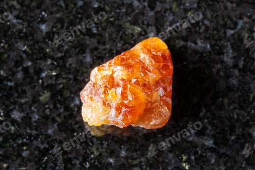 Preview: sample of raw scheelite mineral on black granite