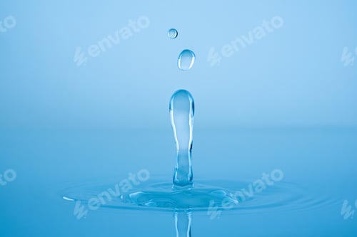 Preview: Water drop splashing into blue water surface