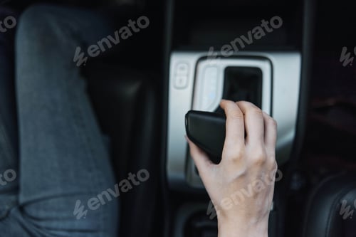 Preview: Remote control held by a person driving a car, with the air conditioner visible in the background