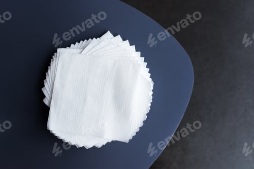 Preview: White paper napkins on a dark table. Copy space, flat lay, top view. Cleaner.