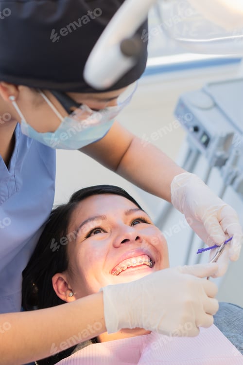 Preview: Young female dentist performed dental procedure to a female patient.