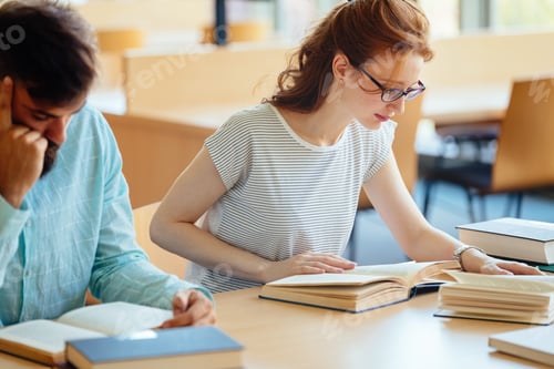 Preview: Young stressed student girl studying pile of books