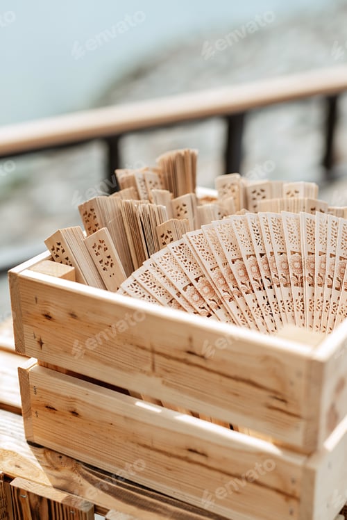 Preview: wooden carved fans in an open box