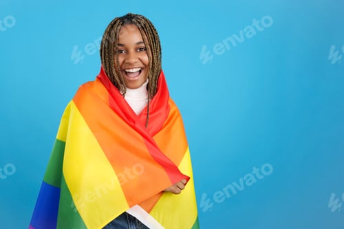 Preview: Proud african woman wrapped in a lgbt rainbow flag
