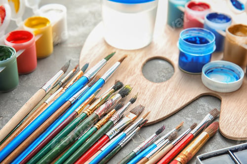 Preview: Different paints, brushes and palette on grey table, closeup