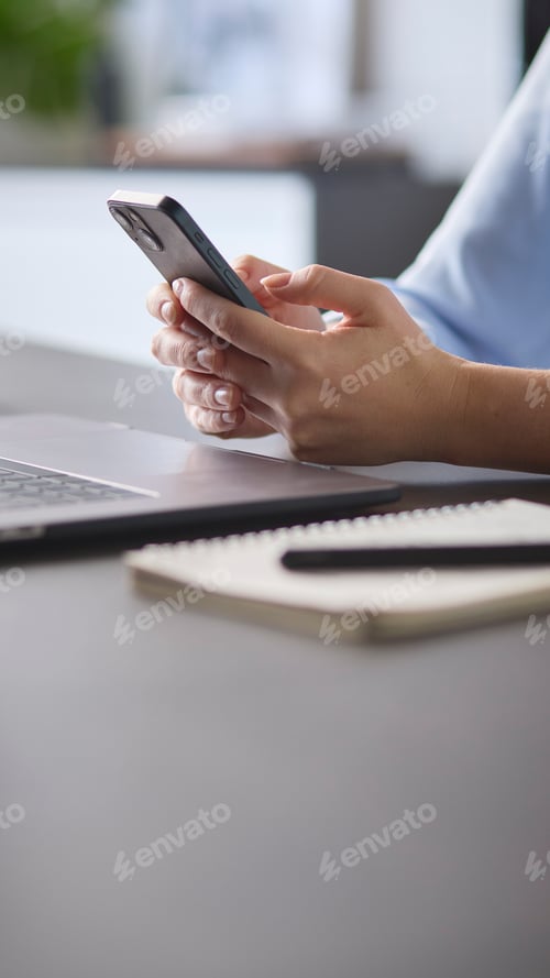 Preview: Close Up Of Woman Using Mobile Phone At Desk Using App Or Searching Social Media