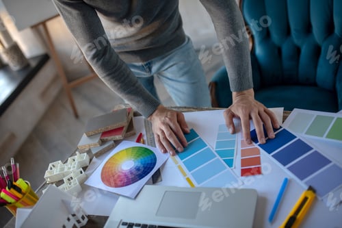 Preview: Interior designer looking at color palette while choosing color