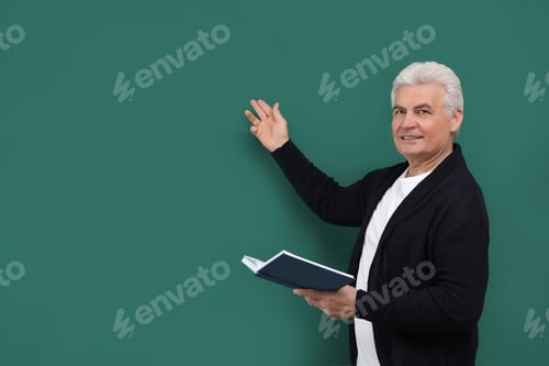 Preview: Portrait of senior teacher with book at green chalkboard, space for text