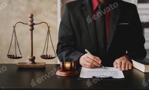 Preview: concept of justice and law A male judge in the courtroom on a wooden table and a male counselor or l