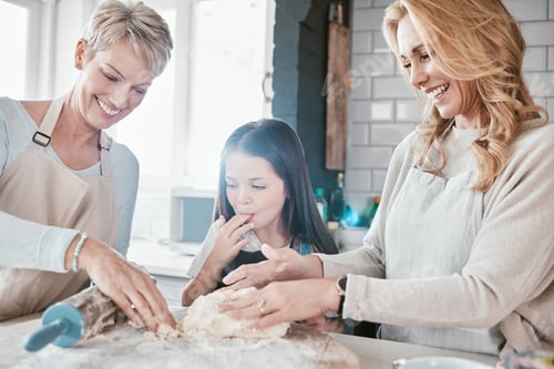 Preview: Family, children and baking with a mother, grandmother and girl in the kitchen learning about cookin