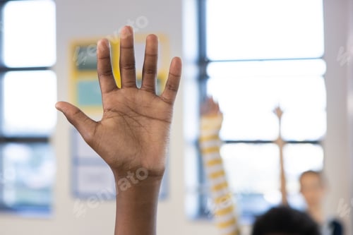 Preview: Raising hand in classroom, african american boy actively participating in school lesson