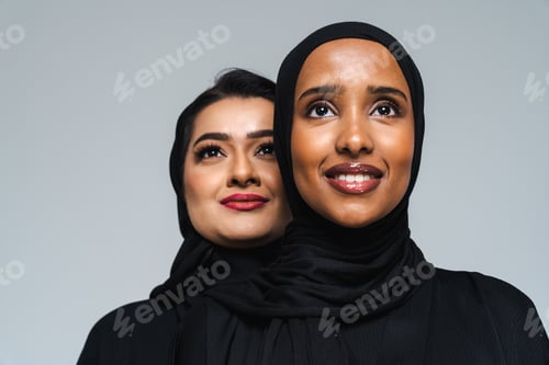 Preview: Beautiful arab middle-eastern women with traditional abaya in studio