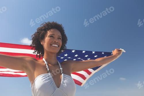 Preview: Woman Celebrates with American Flag on Sunny Day