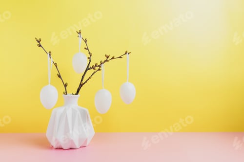 Preview: Happy Easter holiday, coming spring. Branches in white vase, hanging eggs