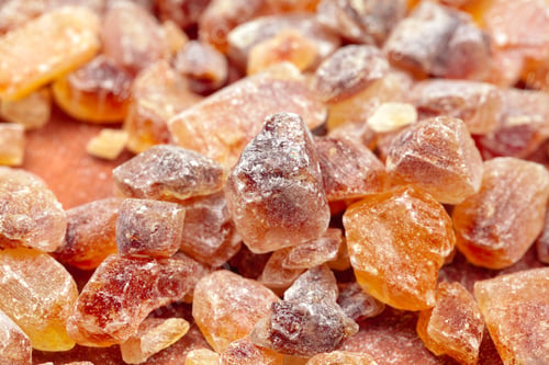 Preview: brown sugar rock organic crystalline close up on dark background