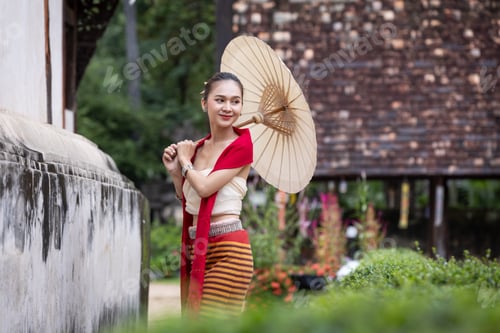 Preview: portrait of young woman in thai dress and holding an umbrella.