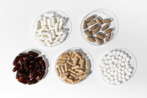 Preview: Various vitamins and dietary supplements in small medical plates. Medicine, medicines.