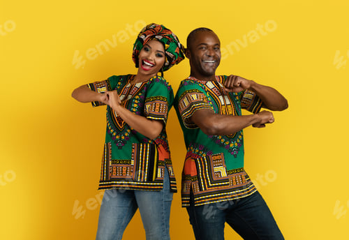 Preview: Funny black man and woman in african costumes dancing together