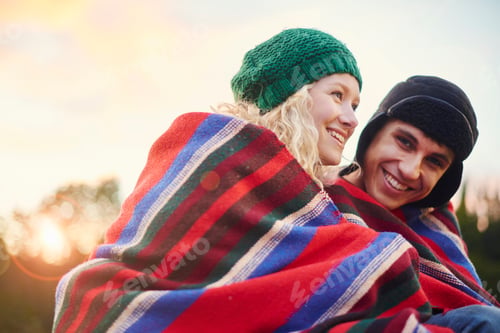 Preview: Portrait of romantic young camping couple wrapped in blanket