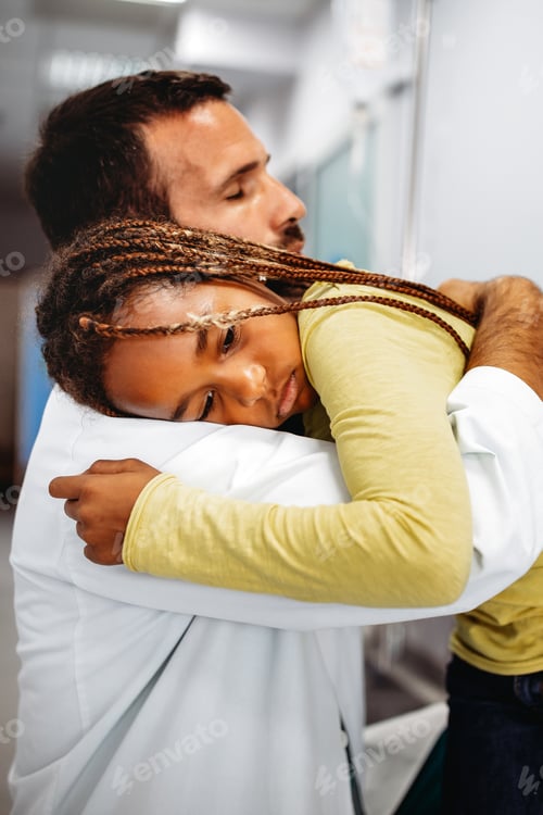 Preview: Doctor having conversation with sad little girl at the hospital. Doctor consoling child