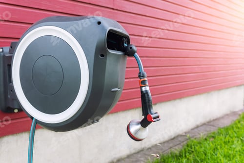 Preview: Wall Mounted Retractable Hose Reel. Modern garden lawn watering tip hose with sprinkler hanged at